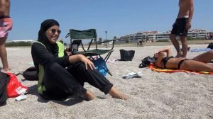 In this image made from video, Nissrine Samali, 20, wears Islamic dress while sitting with her friends by the beach, in Marseille, France, Thursday, Aug. 4, 2016. The mayor of a town outside Marseille said Thursday he intends to ban a swim-day for women at a local park next month, citing a risk to public order because swimmers will be required to cover up from chest to knee. Swimmers have been asked to respect the Islamic notion of "awra," a reference to parts of the body to be hidden â€” causing concern among some in secular France. (AP Photo)/LON138/16217708860178/IMAGE MADE FROM VIDEO/1608042154